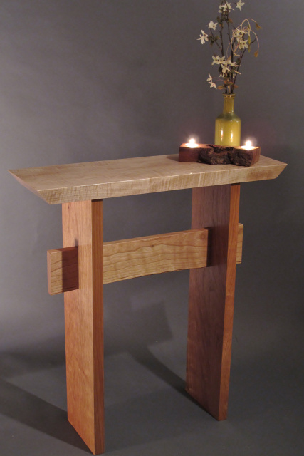 Beautiful contrasting wood colors are shown here in this Tiger Maple with Cherry wood furniture combination.  Our modern zen statement table features simple lines and a gentle curve creating artistic side tables for hallway, entry or accent tables for small spaces.